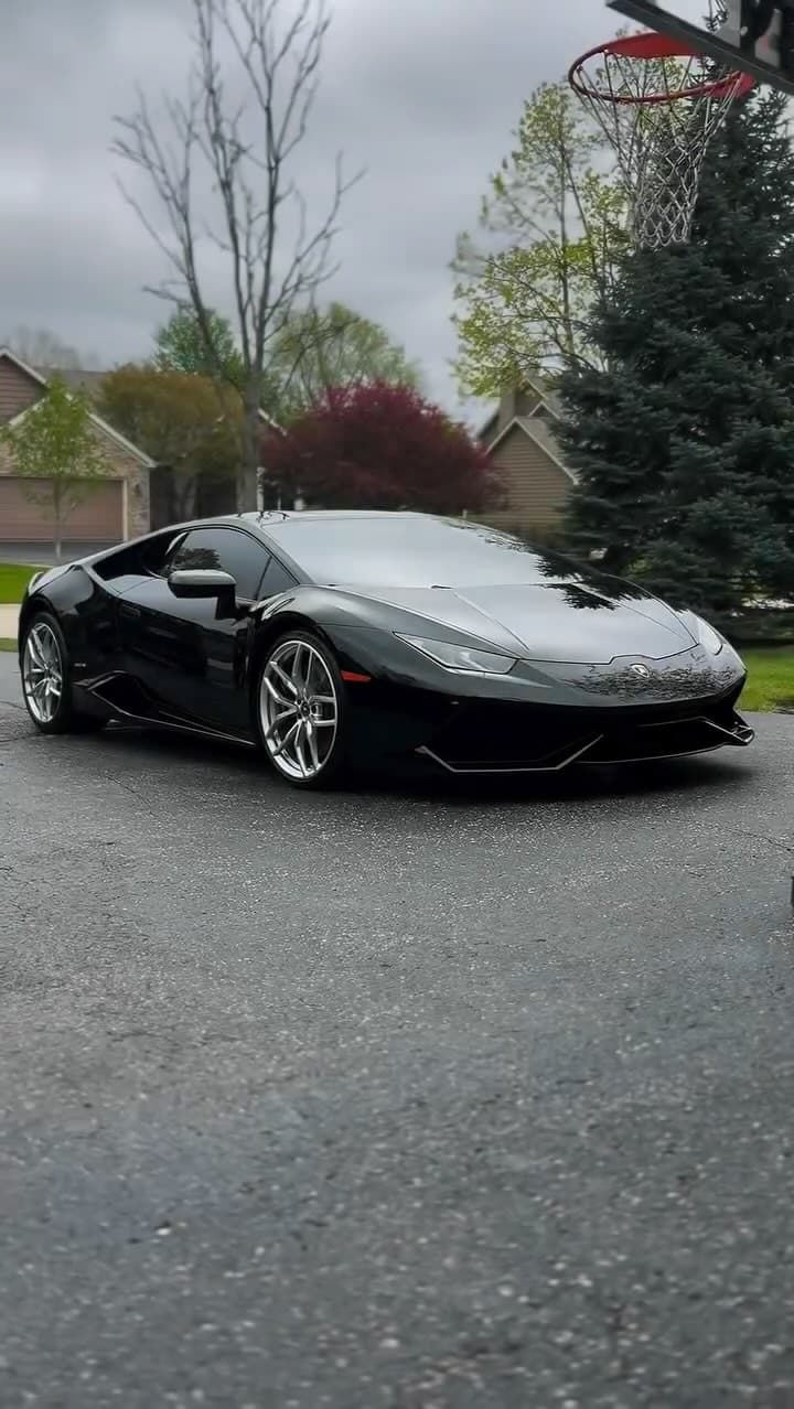 Black Lamborghini Huracán on a driveway