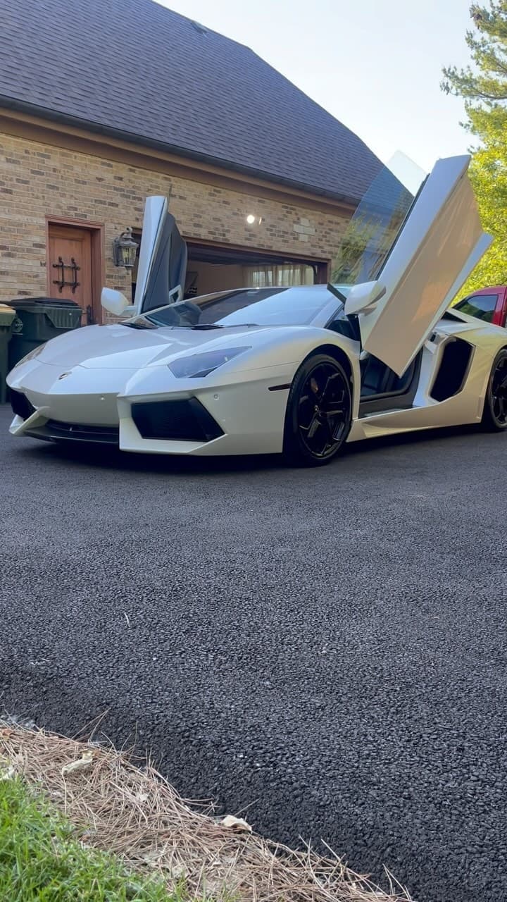 White Lamborghini Aventador with scissor doors open