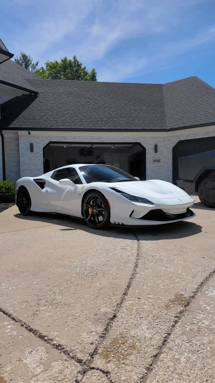 White Ferrari F8 on a residential driveway