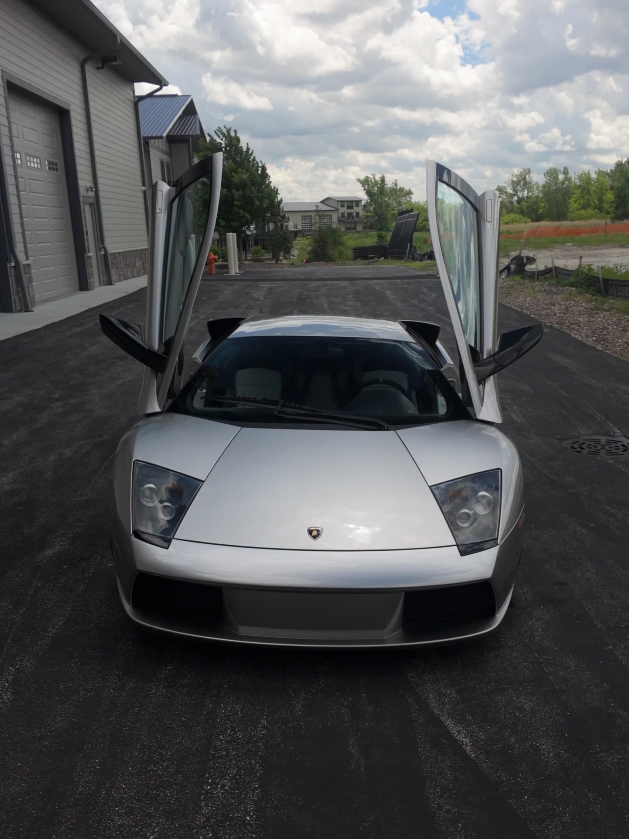 Silver Lamborghini Murciélago with scissor doors open